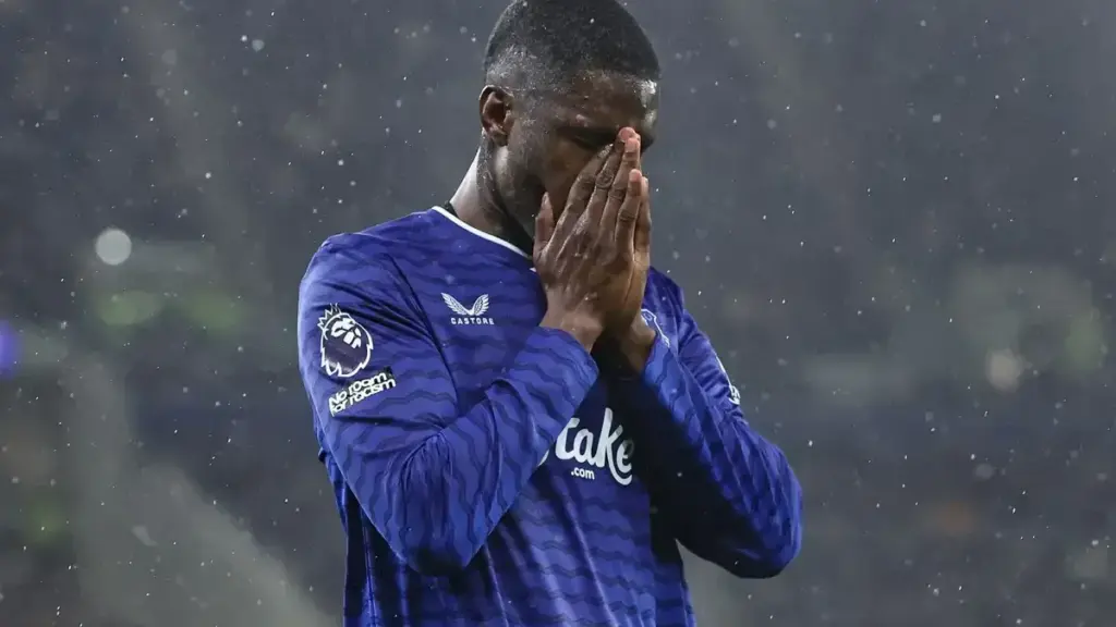 Thierno Barry in an Everton kit, reacting emotionally on the pitch in wet conditions